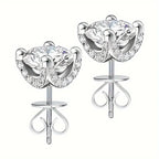 Pair of silver earrings with clear gemstones on a white background