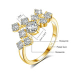 Gold ring with diamond-like stones and measurements on a white background