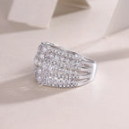 Silver ring with diamond accents on a light background