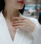 Close-up of a person wearing a silver ring with a blurred background