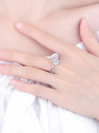 Silver ring with a diamond on a hand against a white background