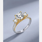Gold and silver ring with three diamonds on a gradient background