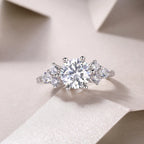Diamond ring with three stones on a light background
