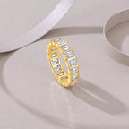 Gold ring with diamond accents on a light gray surface