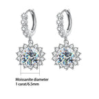Silver hoop earrings with round gemstones on a white background