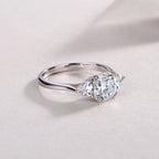 Silver ring with a pear-shaped diamond on a light background