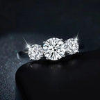 Three-stone diamond ring on a dark background