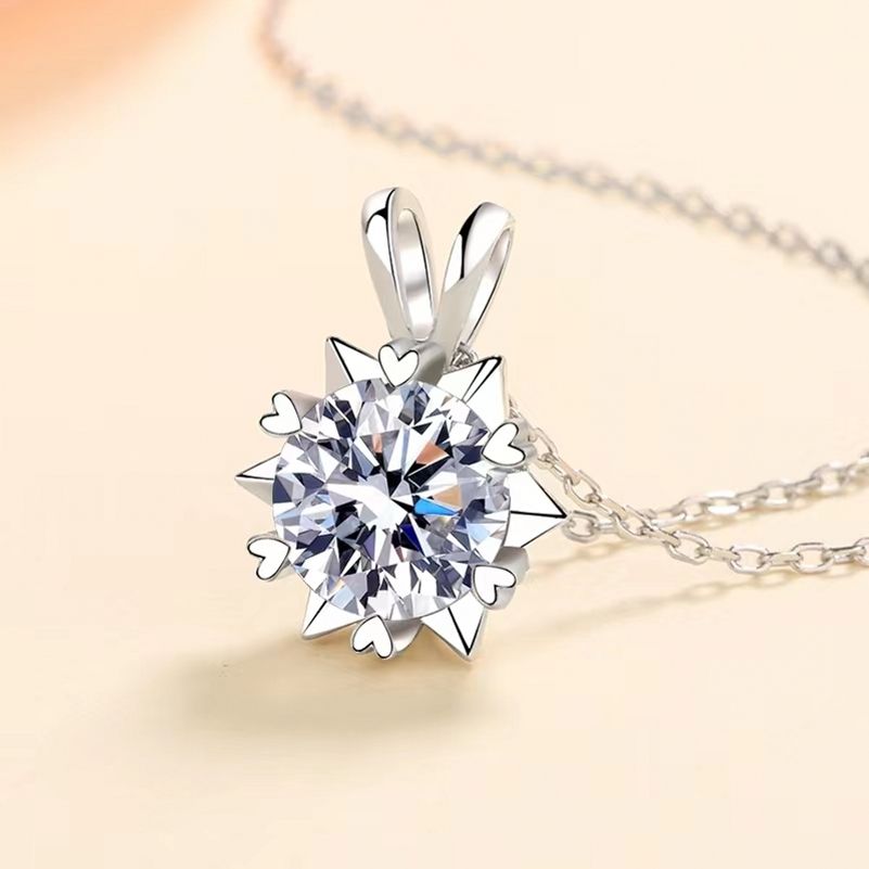 Silver pendant with a large diamond on a light background