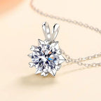 Silver pendant with a large diamond on a light background