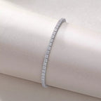 Silver bracelet on a beige cushion with a soft focus background