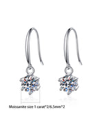 Silver earrings with Moissanite stones on a white background