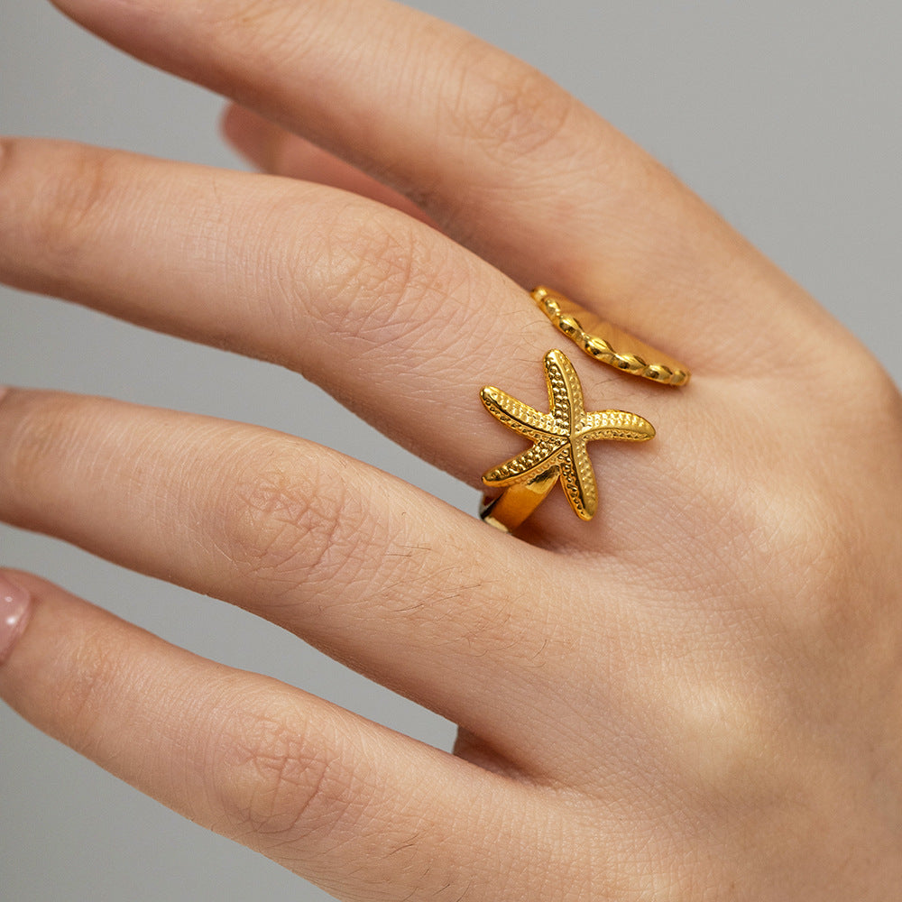 Adjustable starfish and seashell wrap ring worn on hand – tarnish-free beach jewelry