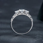 Silver ring with diamond accents on a dark background